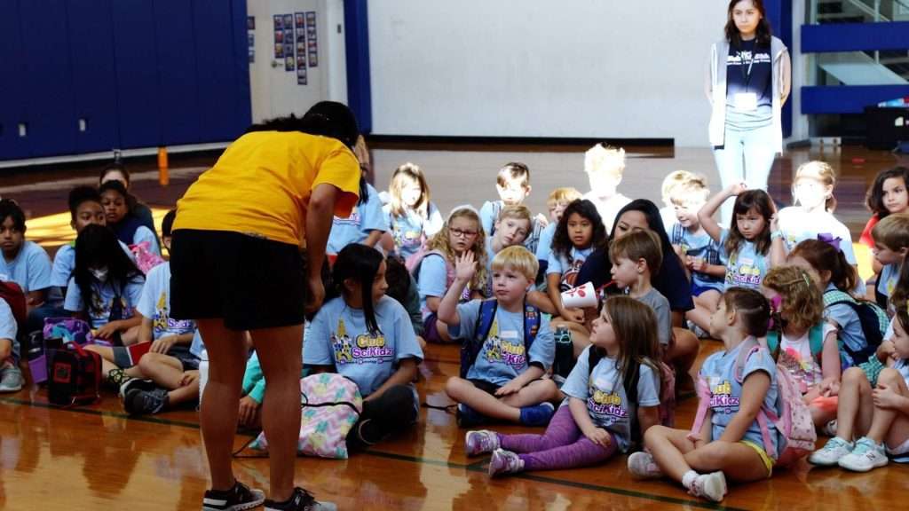 STEM Summer Camps for kids counselor talking to a group of campers